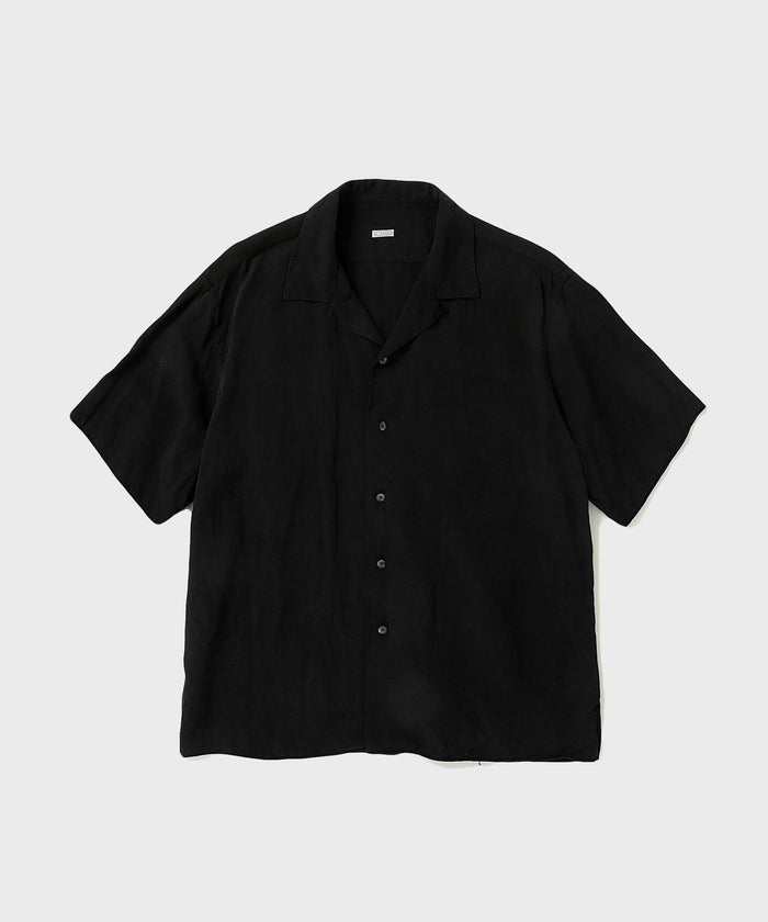 Black short-sleeve open-collar men's silk-linen shirt laid flat on a light background.