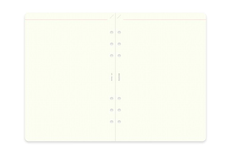 Open A5 refill memo pad showing two facing 2mm grid pages and six punched binder holes.