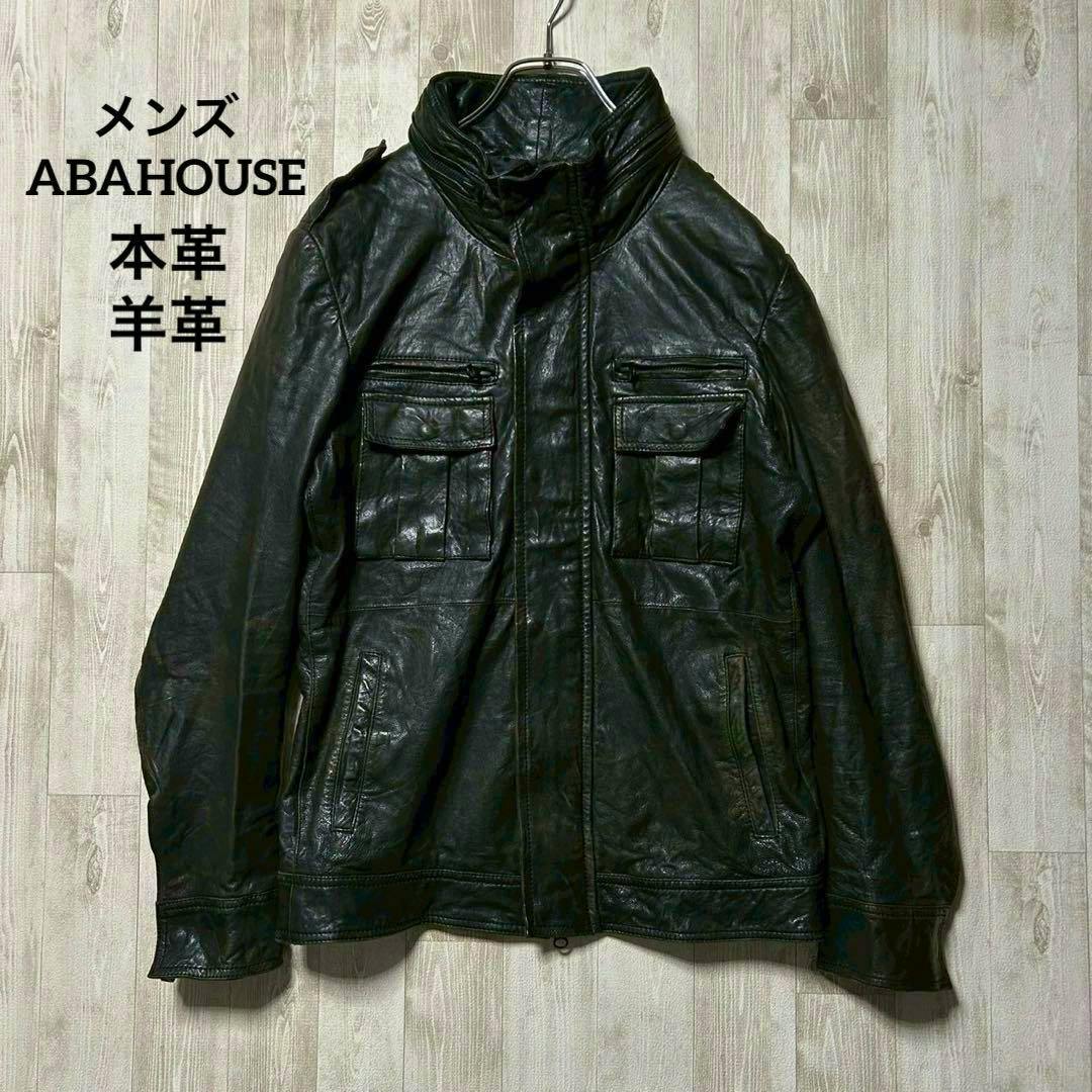 Front view of a black ABAHOUSE lambskin military-style jacket laid flat on a wooden floor.