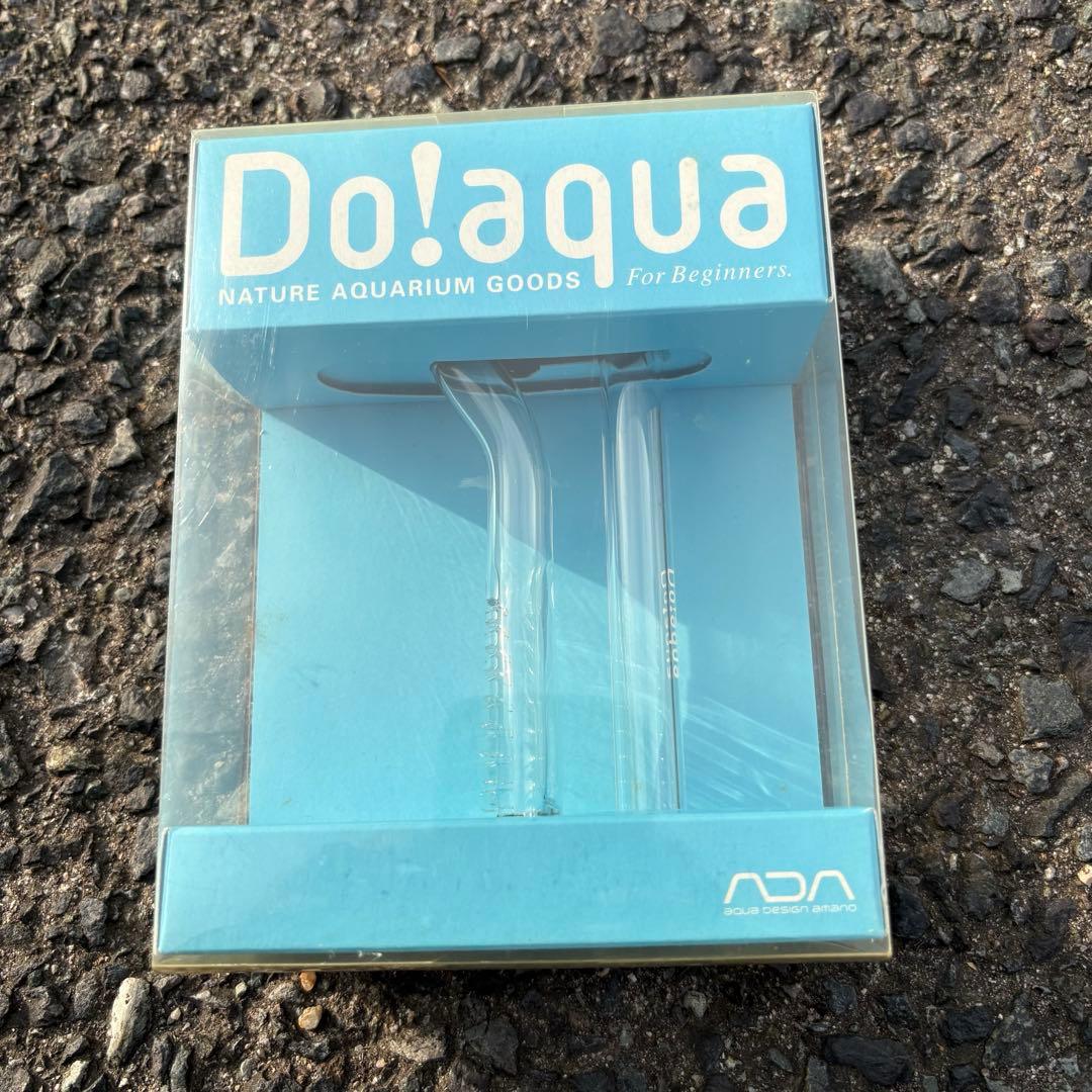 Packaged ADA Do!aqua glass aquarium water intake pipe (MV-1) in blue retail box showing two clear glass pipes.
