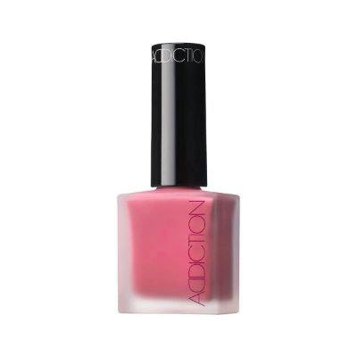 Photo of a pink cheek polish bottle with a black cap and ADDICTION logo.