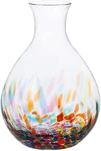 Clear glass sake bottle with a teardrop shape and multicolored flecked pattern near the base on a white background.
