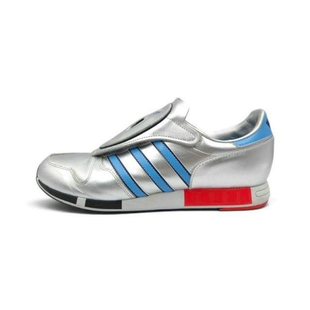Side view of an ADIDAS 2021 Micropacer metallic silver sneaker with blue three stripes and red/black midsole accents on a white background.