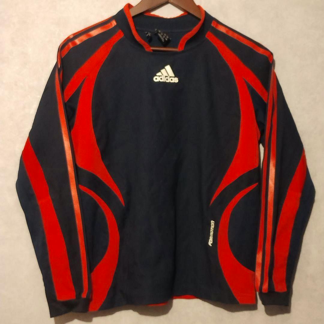 Front view of an adidas navy and red long-sleeve Clima365 polyester jersey hanging on a hanger.
