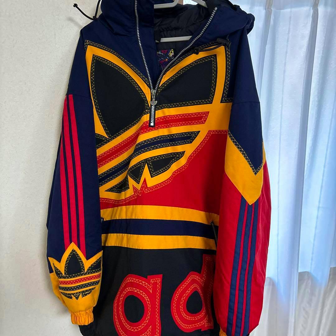 Front view of the Descente-made adidas padded anorak parka showing navy, red, and yellow colorblocking and a large adidas trefoil logo.