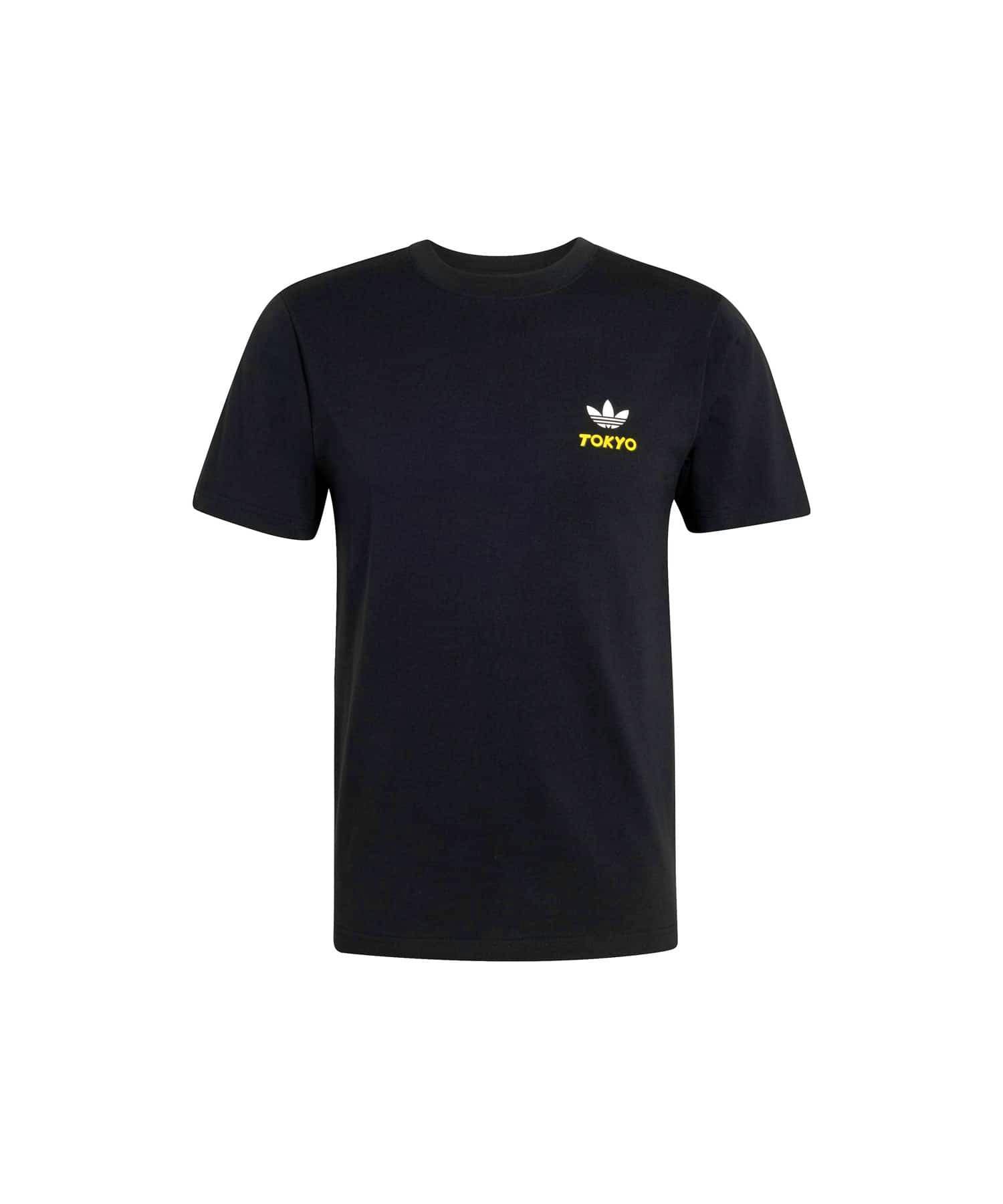 Front view of a black adidas T‑shirt on a white background showing a small white trefoil and yellow "TOKYO" text on the chest.