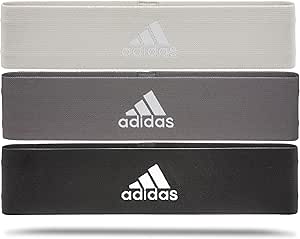 Three adidas exercise resistance bands in light gray, dark gray, and black stacked horizontally with the adidas logo visible.