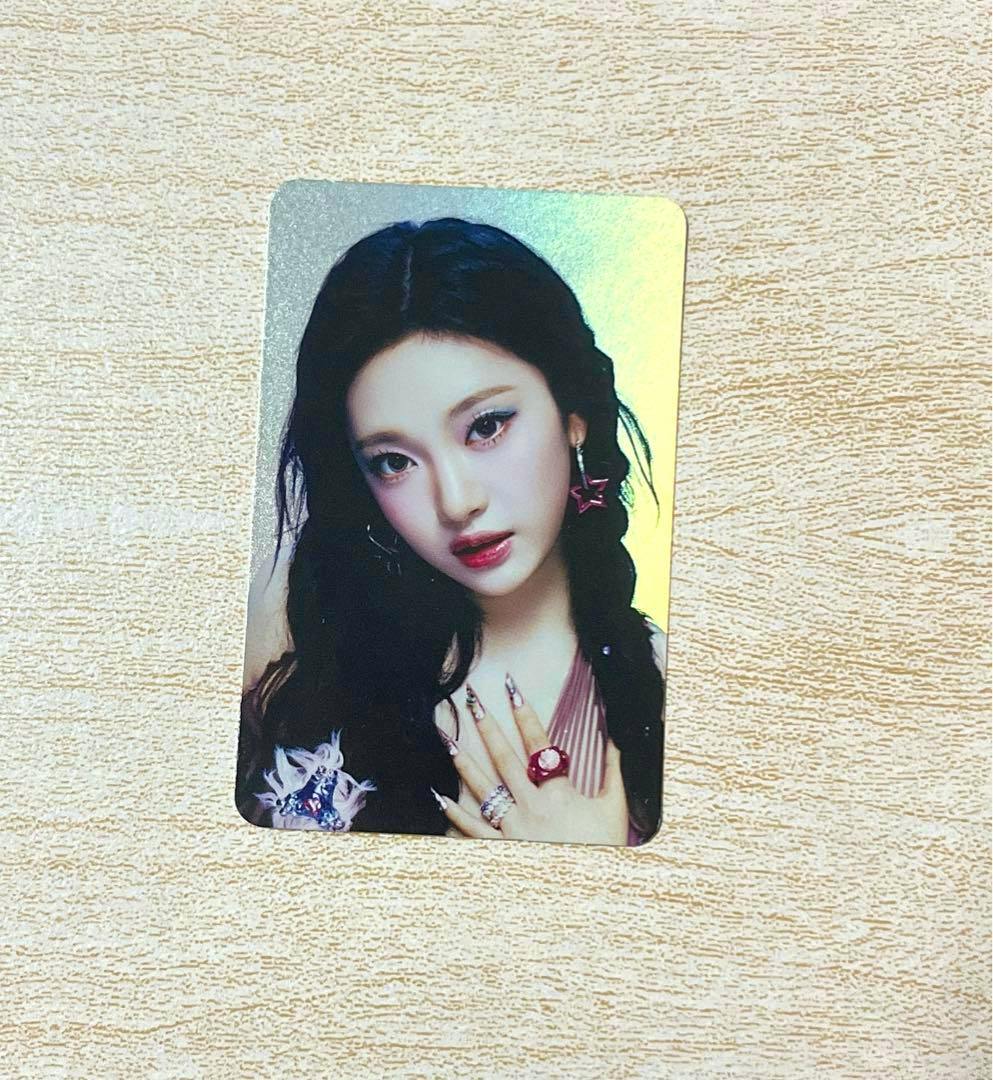 Photocard for aespa ニンニンbetter things hologram showing a portrait-style photocard placed on a wood surface.