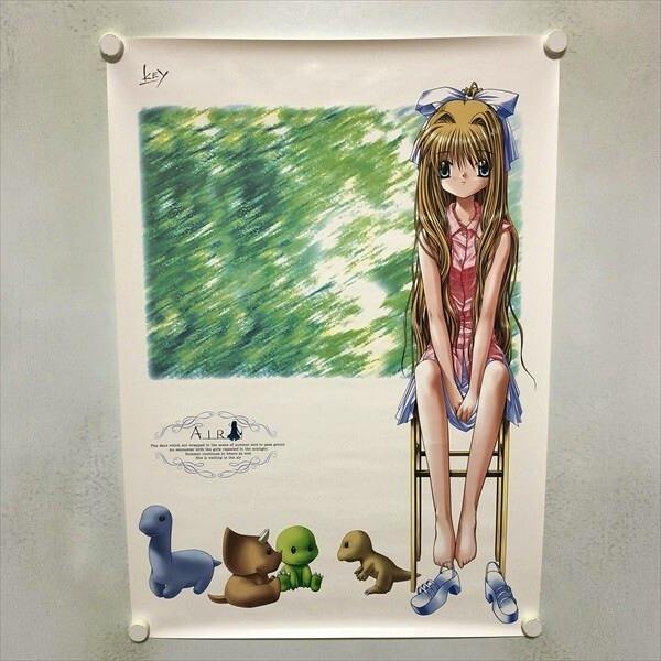 Photo of the AIR B2 poster showing an anime girl seated on a chair with small toy-like animals along the bottom, pinned to a wall.