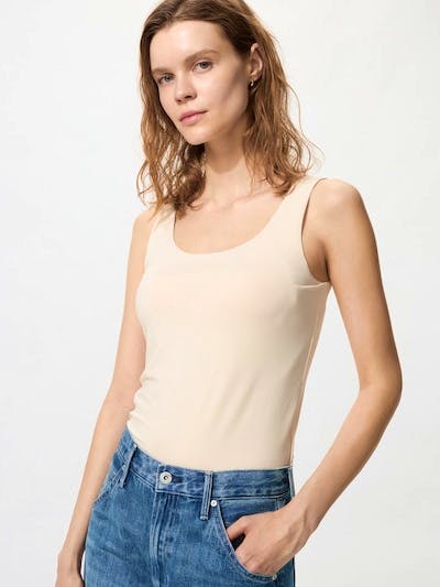 A model wearing a beige Airism bra tank top shown from the front.