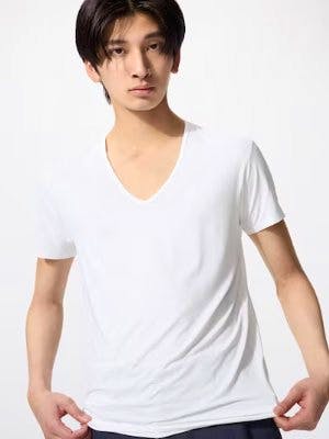 Male model wearing a white T-shirt shown from the front.