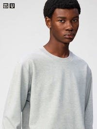 Male model wearing a light gray long-sleeve T-shirt shown from the chest up.
