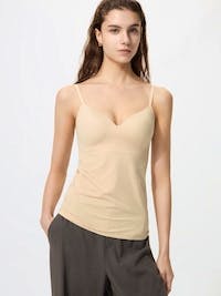 Model wearing a beige V-neck seamless bra camisole.