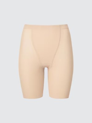 Beige Airism shaper shorts shown front-facing on a light background.