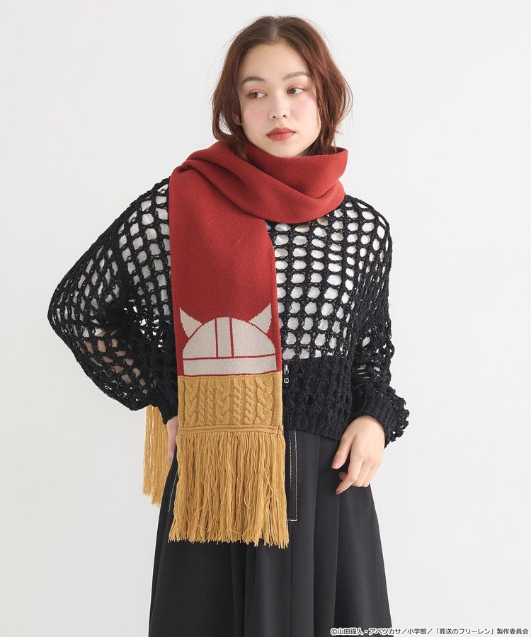 Model wearing the acrylic scarf in red and mustard featuring a white helmet motif and long fringe.