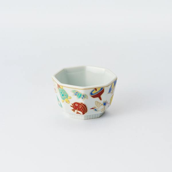 Octagonal Kutani-yaki small ceramic bowl decorated with colorful auspicious motifs on a white background.
