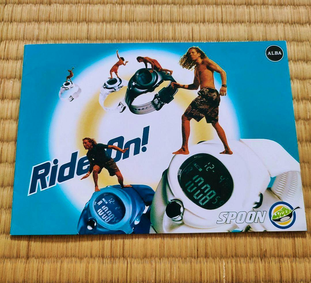 Front cover of an ALBA SPOON pamphlet showing watch images, surfers, and the words "Ride On!" and "SPOON" on a blue background.