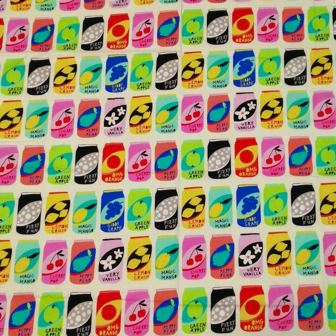 Cotton fabric showing a repeating colorful print of illustrated soda cans labeled with flavors including "Lemon Crush".