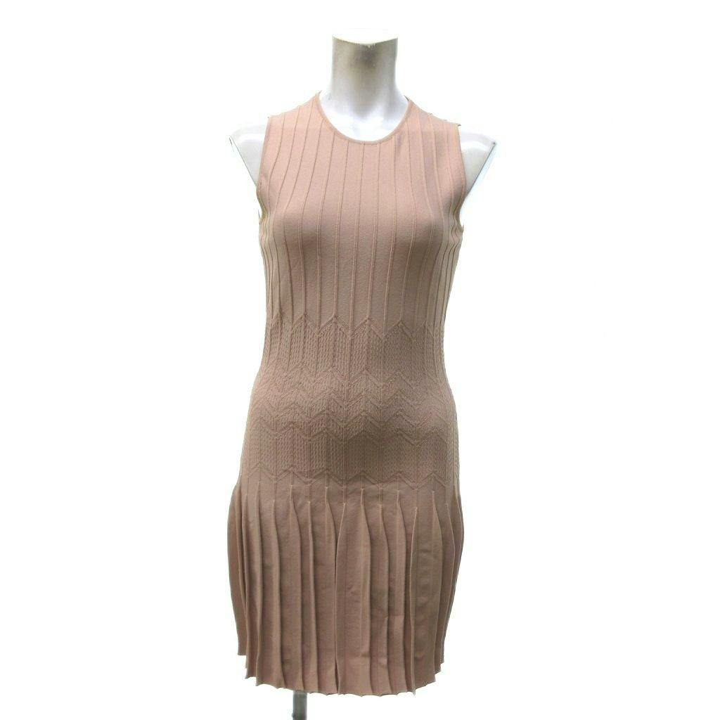 Front view of the beige sleeveless knee-length Alexander McQueen dress displayed on a white mannequin.