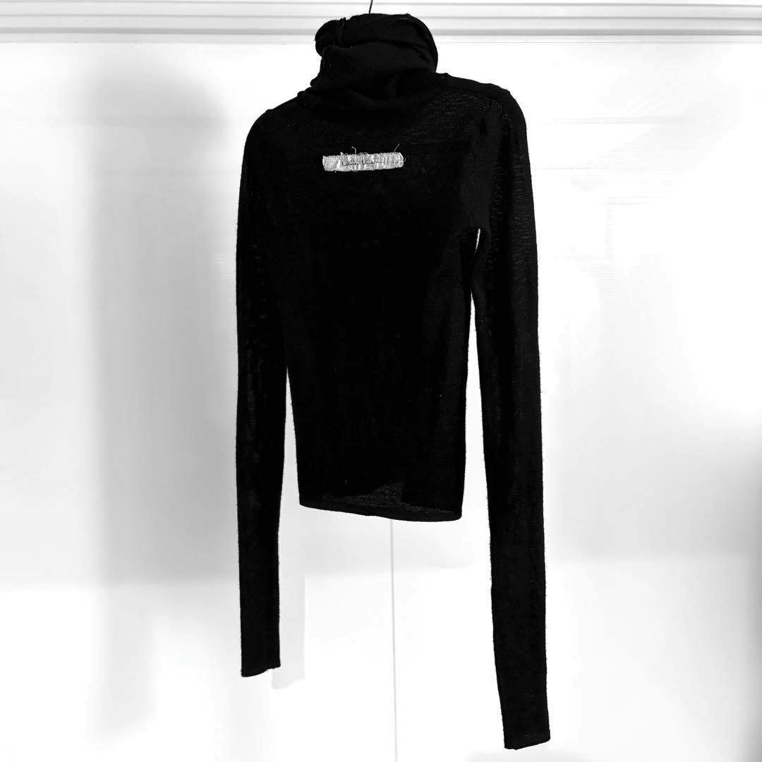 Black alice auaa turtleneck wool knit sweater hanging on a hanger against a white background.