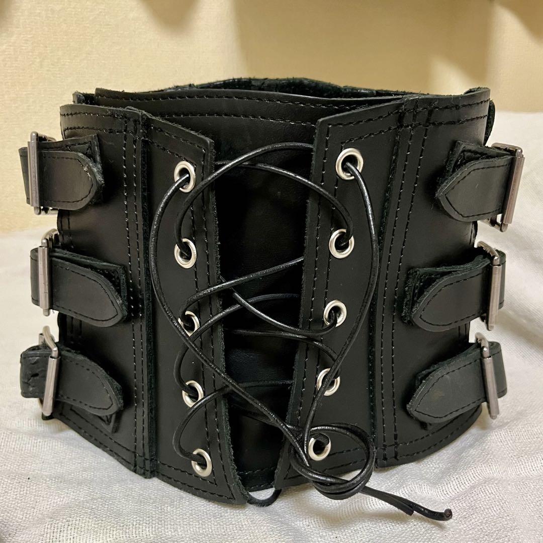 Black leather neck corset with center lace-up and three buckle straps on the side.