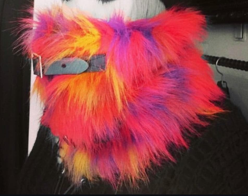 A multicolored polyester neck warmer worn around a person's neck.