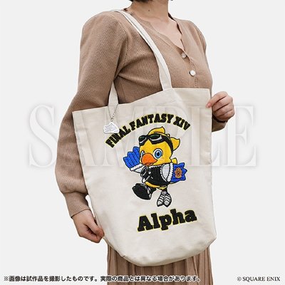 Sagara embroidered tote bag (Alpha design) held by a model, showing an embroidered chocobo and the text "FINAL FANTASY XIV Alpha".