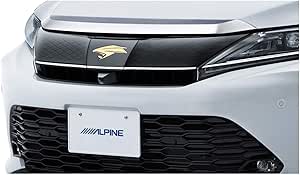 Front grille of a Harrier showing an Alpine-branded license plate and a small grille-mounted front camera installed below the emblem.