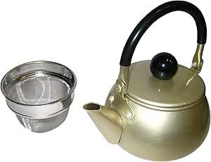 Gold aluminum teapot with a black handle and a metal tea infuser placed beside it.