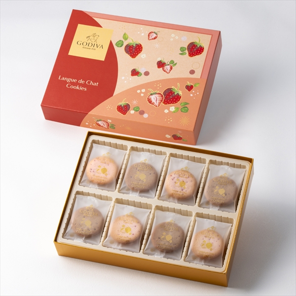 An open decorative box of strawberry langue de chat cookies showing eight round cookies in a gold tray.