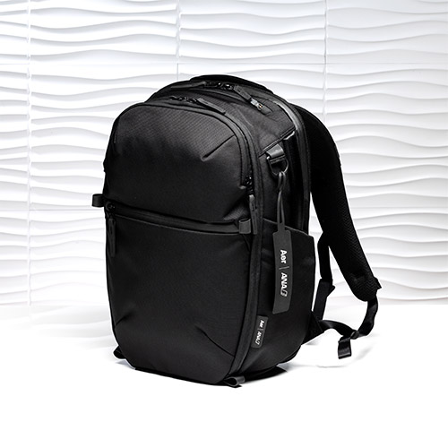 A black Aer for ANA City Pack Pro 2 20L backpack photographed upright against a white textured background.