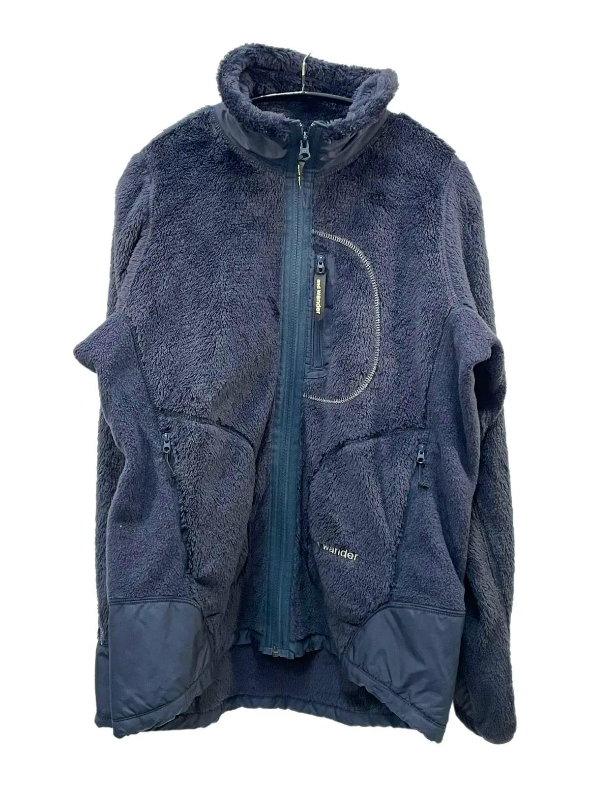 Front view of a navy men's high-loft fleece jacket with central zipper, zip pockets, and stand collar hung on a hanger.
