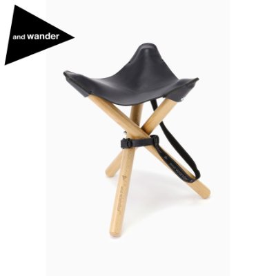 and wander TAKIBI leather stool in black with three wooden legs shown assembled on a white background.