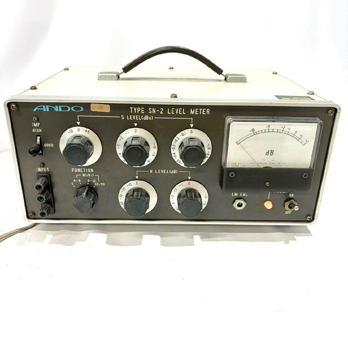 Front view of the ANDO Type SN-2 level meter showing control knobs, input jacks, and an analog dB meter.