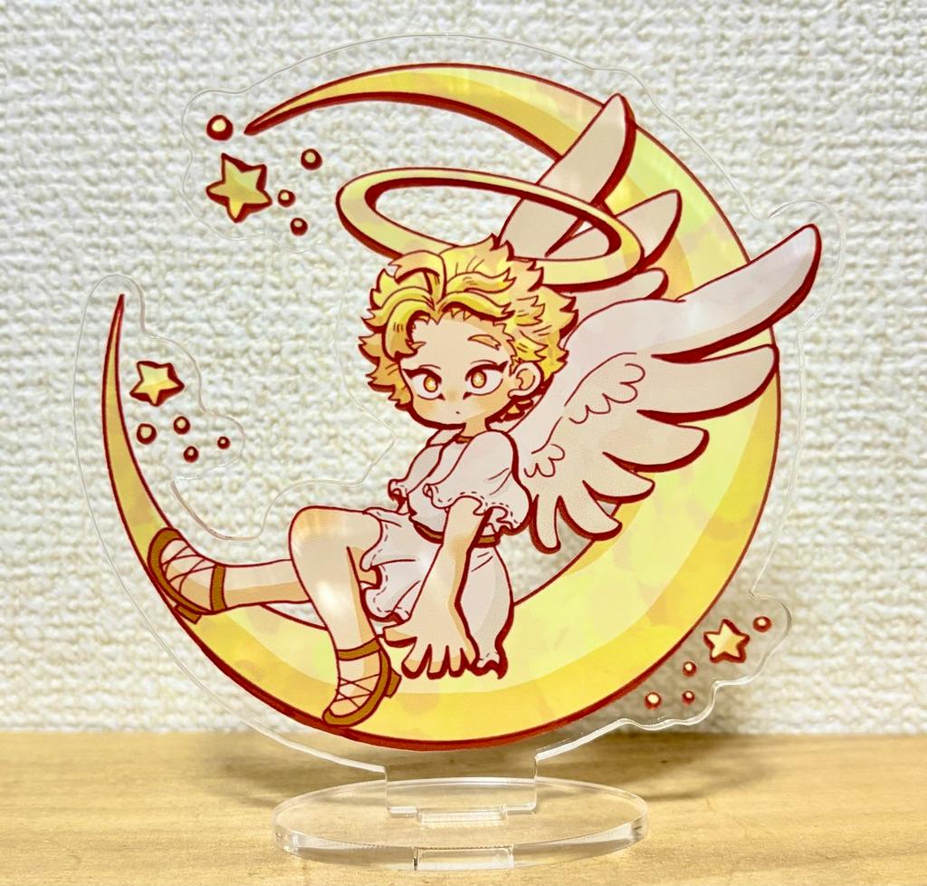 Photo of the acrylic stand showing an angel character sitting on a crescent moon mounted on a clear plastic base.
