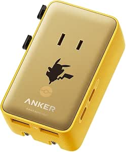 Anker Pikachu travel adapter in yellow with a gold faceplate, Pikachu silhouette, and visible USB-C and USB-A ports.