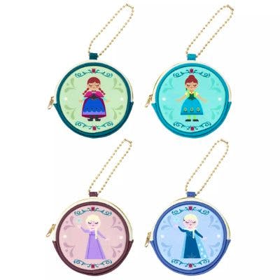 Four round synthetic-leather pouches with printed Anna and Elsa designs, each with a short gold ball chain.