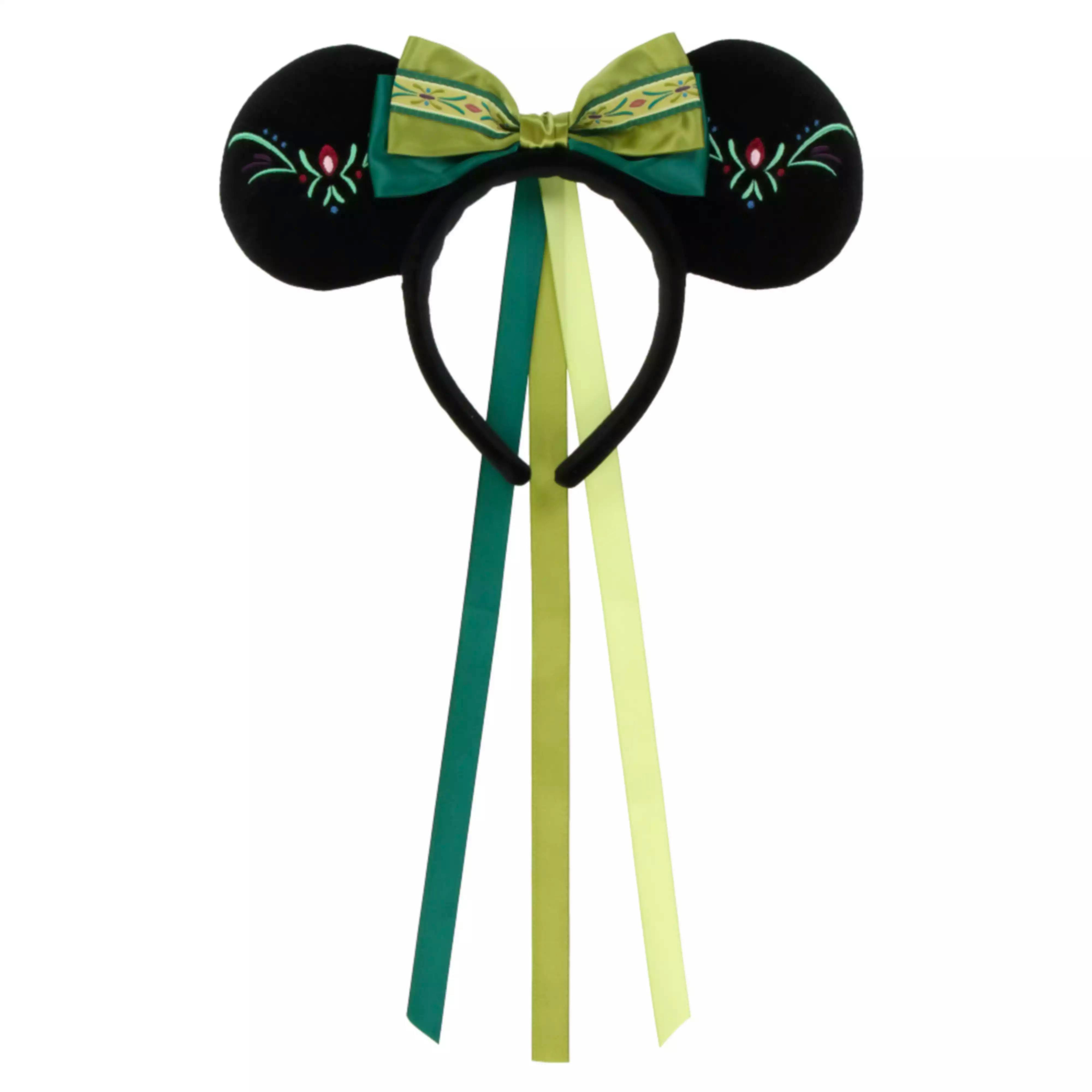 Decorative hairband with black round ears, a green patterned bow, and long green ribbon tails.