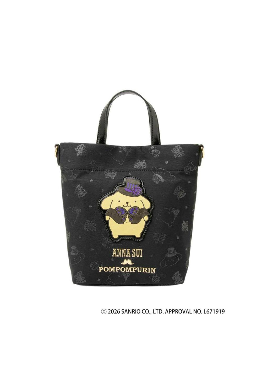 Front view of the ANNA SUI x POMPOMPURIN mini shoulder bag showing the black fabric, a Pompompurin character patch, and ANNA SUI / POMPOMPURIN logo text.