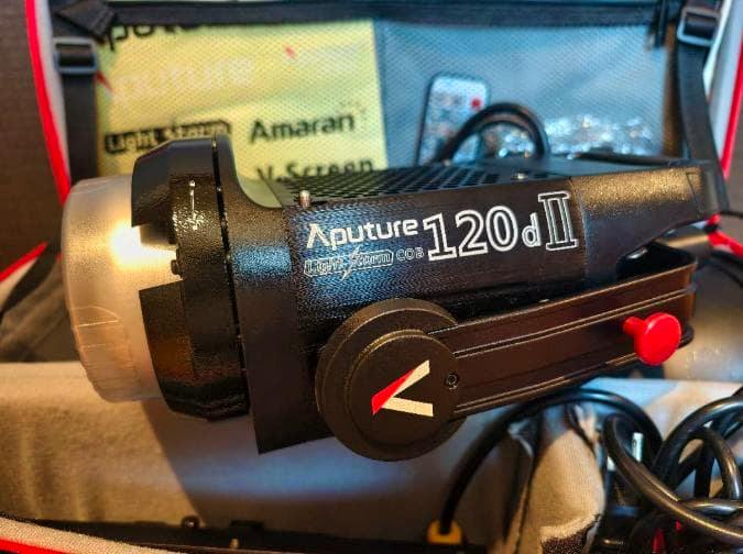 Close-up of the Aputure LS C 120d II Light Storm head showing the 120d II label and yoke inside a padded case.