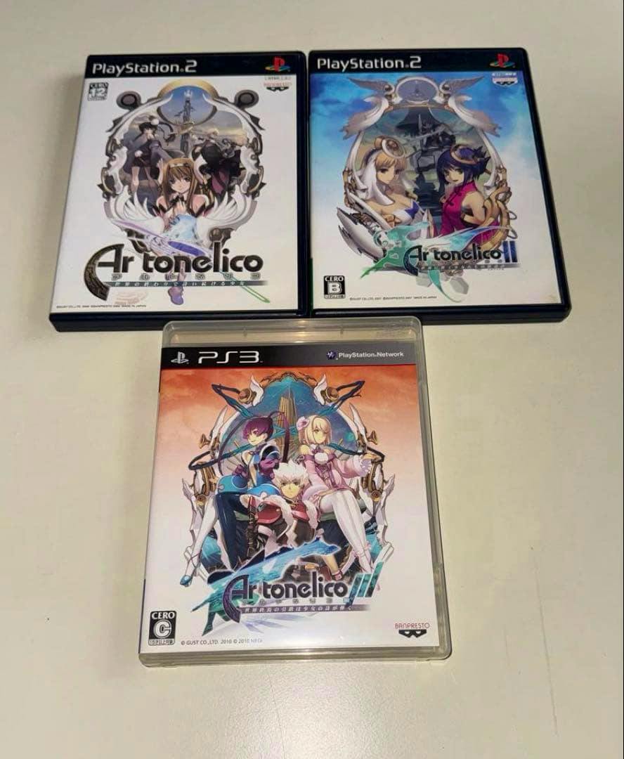 Three Ar tonelico game cases (two PlayStation 2 and one PlayStation 3) laid on a light surface, showing the front cover art.