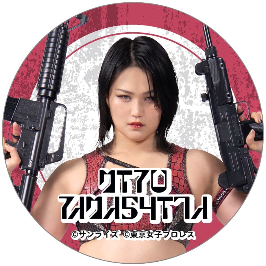 Round can badge design showing a female wrestler holding two rifles with a stylized background and Japanese text.