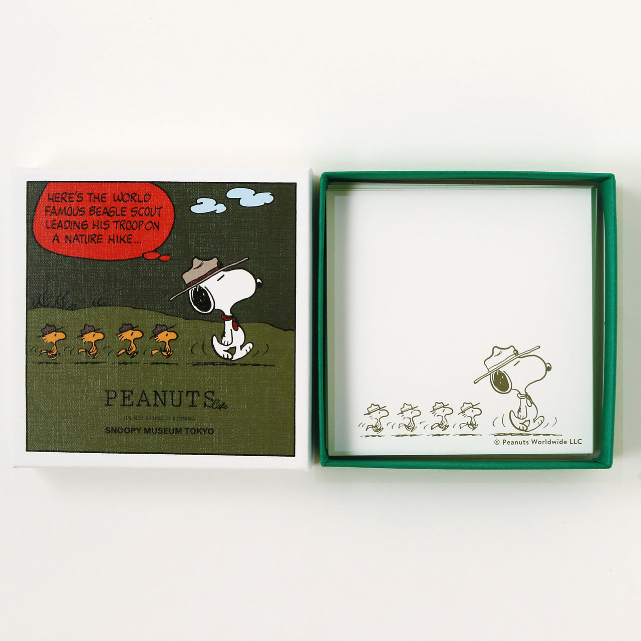 Square paper art box shown open with a printed Snoopy and Woodstock illustration on the lid and on the inner tray.