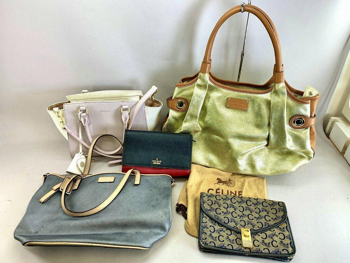 Multiple handbags and small bags—including a green tote, gray shoulder bag, pink handbag, and a monogram wallet—arranged on a light background.