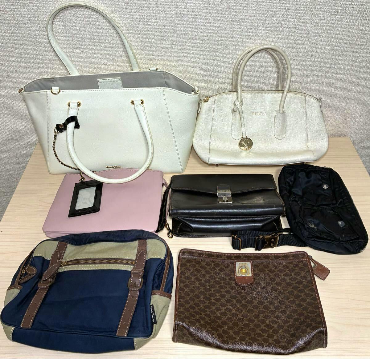 Assorted branded bags laid out on a tabletop, showing multiple styles and colors.