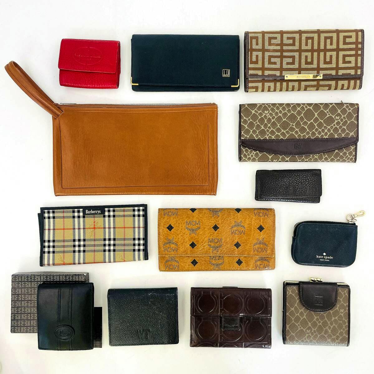 Thirteen assorted branded wallets, coin purses, and a clutch arranged on a white background.