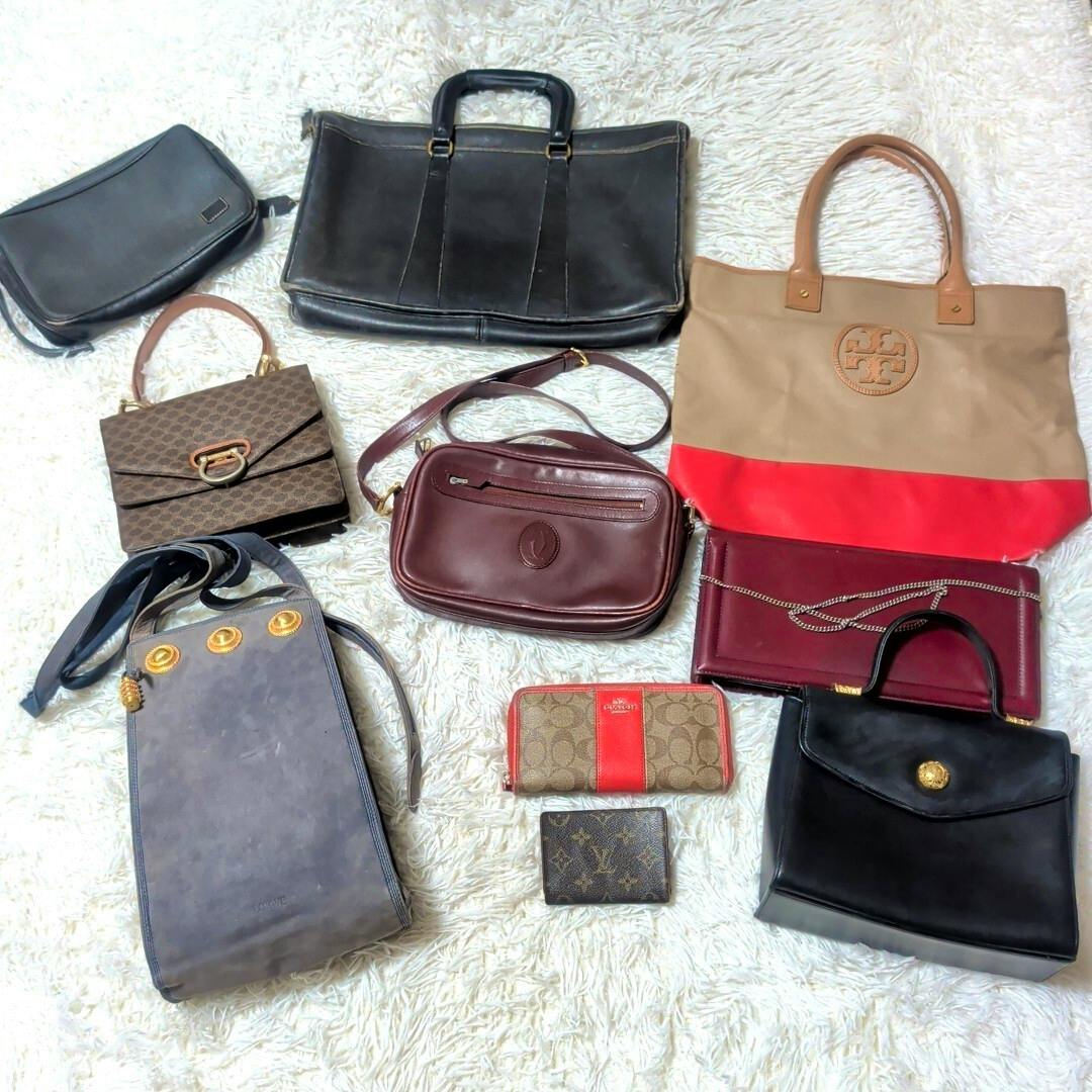Assorted branded bags, wallets, and pouches arranged on a white shag rug, shown together as a set.