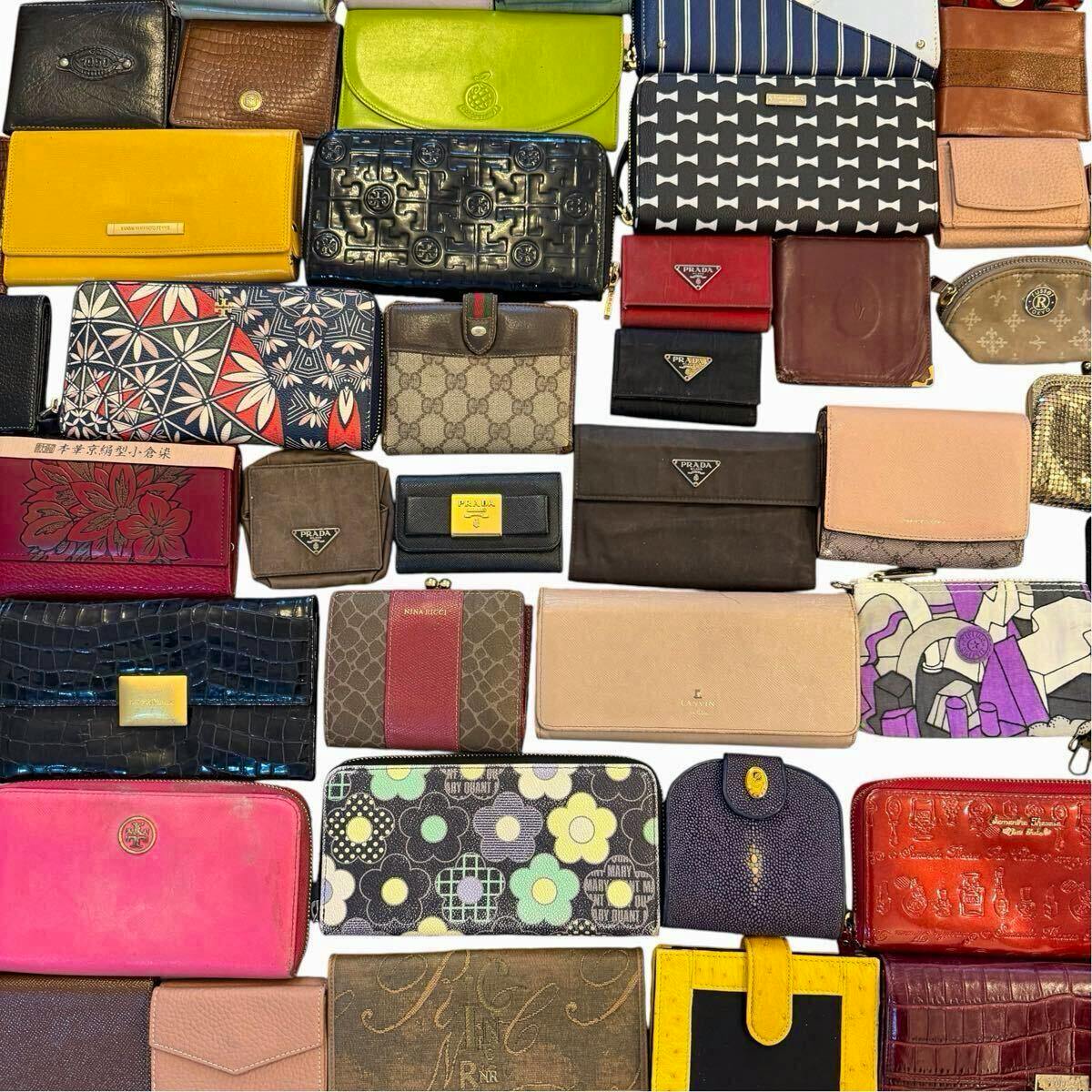 Many assorted wallets and small bags from various brands arranged on a white background.