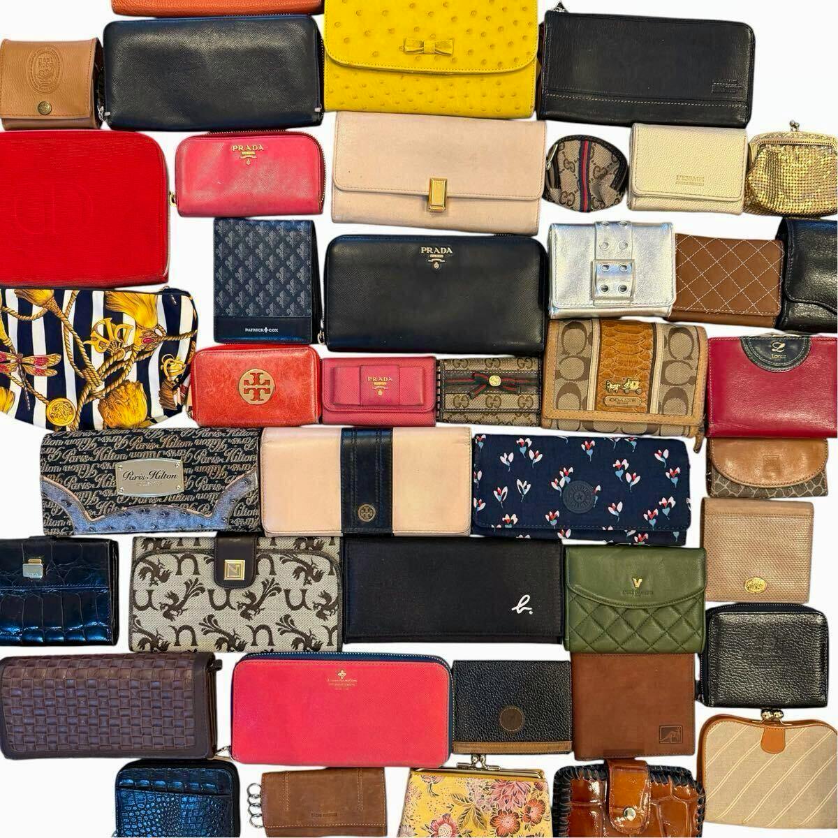 Multiple wallets and small leather goods from various brands arranged flat on a white background.