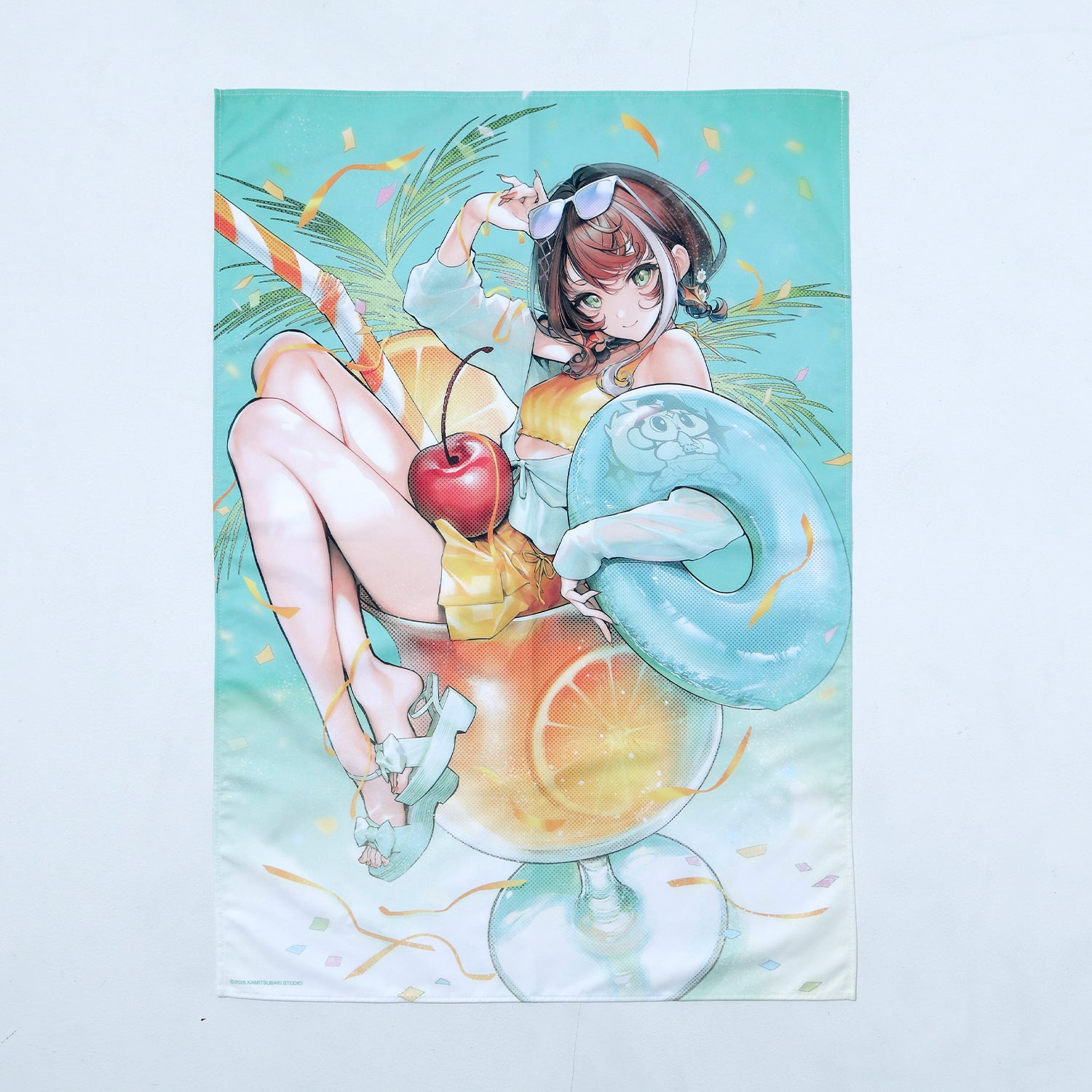 Polyester bath towel laid flat showing a full-color illustration of an anime-style girl in swimwear holding an inner tube and sitting in a large drink with a cherry.